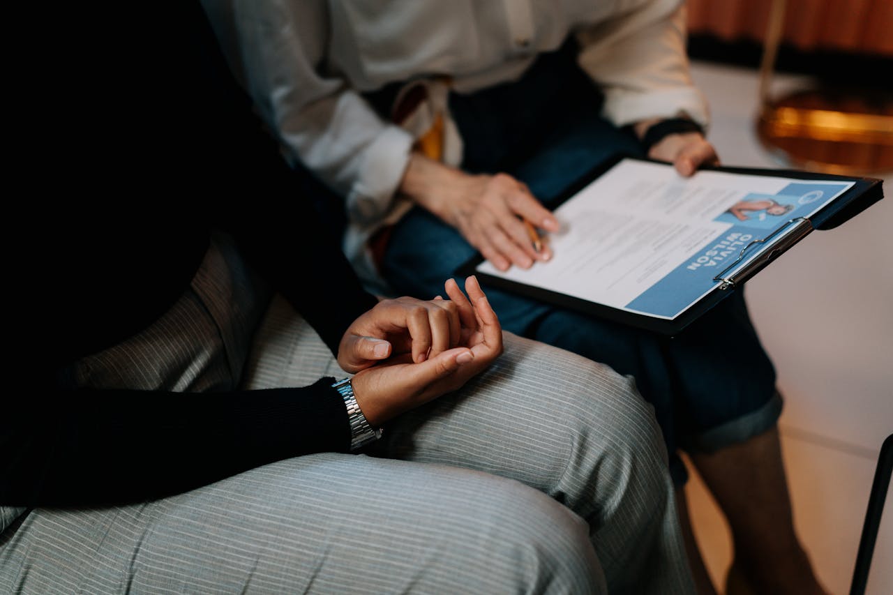 about-01 Two professionals reviewing a resume in an office setting, focused on teamwork.